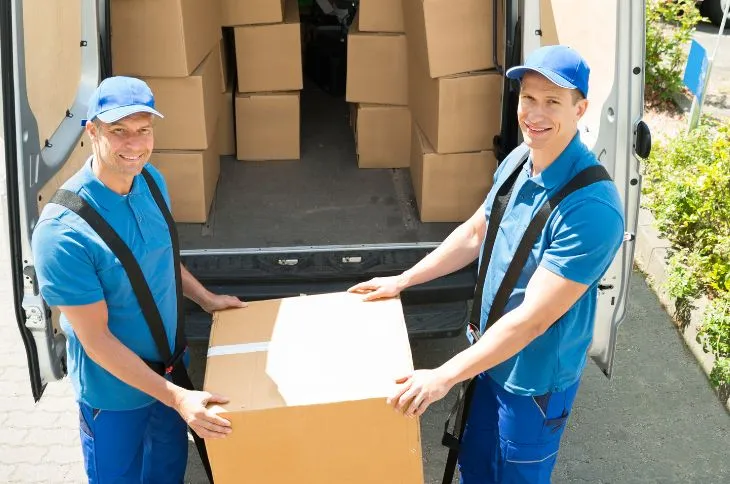 Movers are carrying heavy box